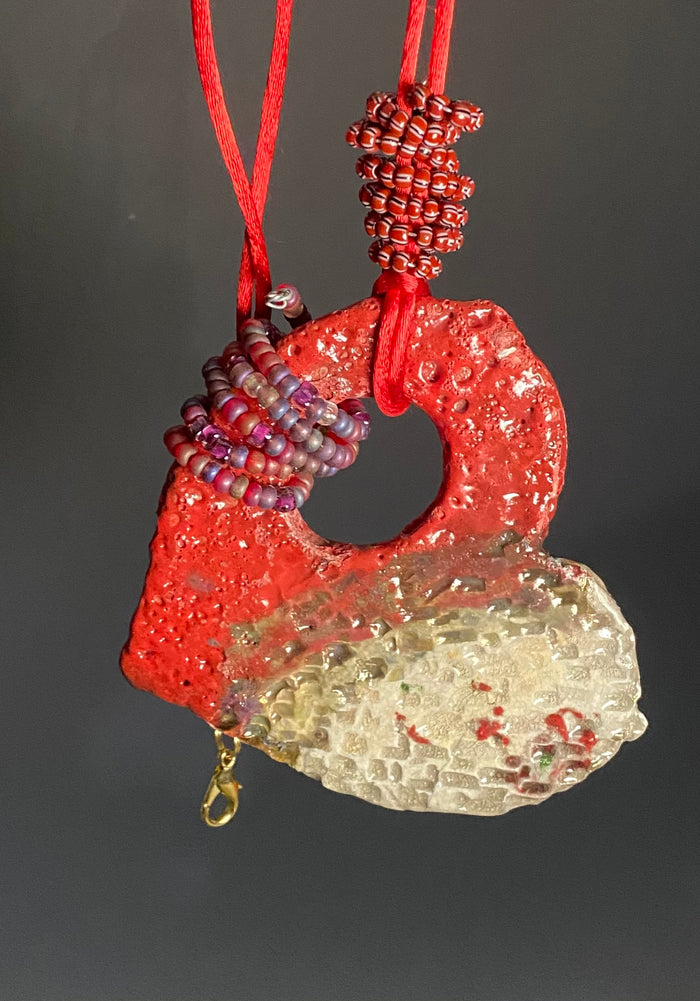 Have A Heart ! Each heart pendant is handmade with love! It is 3"x 3" and weighs approx. 3ozs. This pendant has a copper gold metallic raku glazes that renders a unique translucent patina. The heart has a textured pattern . It holds a spiral of red mini beads on a spiral copper wire. This pendant has a nice 12" red suede cord!