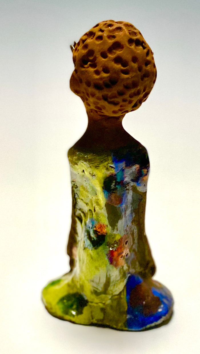 Adisa stands 7' x 4"x 2" and weighs 10.3 ozs. She has bright  dark eyes and a nice honey two tone brown complexion Her long trademark arms rest at her side. Adisa dress is a loving glossy blue and yellow mix with copper flashes.