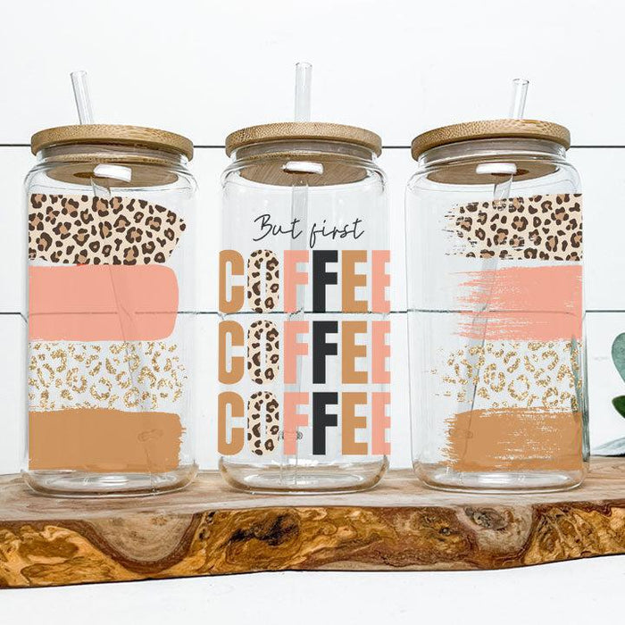 Libby Glass Can Tumbler with “But First Coffee” phrase and neutral brush stroke design, perfect gift for coffee lovers.