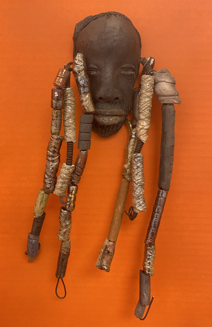 Meet Cain! You Like Wise men; You gotta Love Cain! I started making art soon after seeing authentic African artwork at the Smithsonian Museum of African Art. I was in total awe. Cole was inspired by my visit there.   Cain is a wise and distinguished  bearded gentleman who has a smoky dark complexion. He is approximately 5" x 11" and weighs 13 ozs. Cain has an aged hairstyle of more than 20 handmade textured clay dreadlocks along with twist of coiled 16 gauge wire.