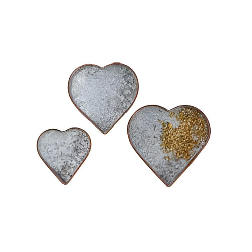 Two small copper heart plates adorned with gold glitters for decorative use