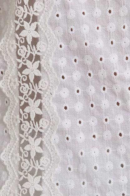 White eyelet fabric with floral lace trim showcases women’s boho chic clothing, shop Daisy