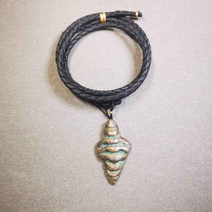 Shankha Divine Conch Badge,Tibetan Buddhist Protective Amulet Pendant,Made of Li - Tibetan Buddhist amulet, close-up detail