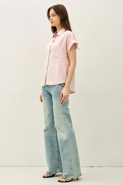 A soft pink short dolman sleeve button shirt with subtle left pocket and short sleeves for casual wear