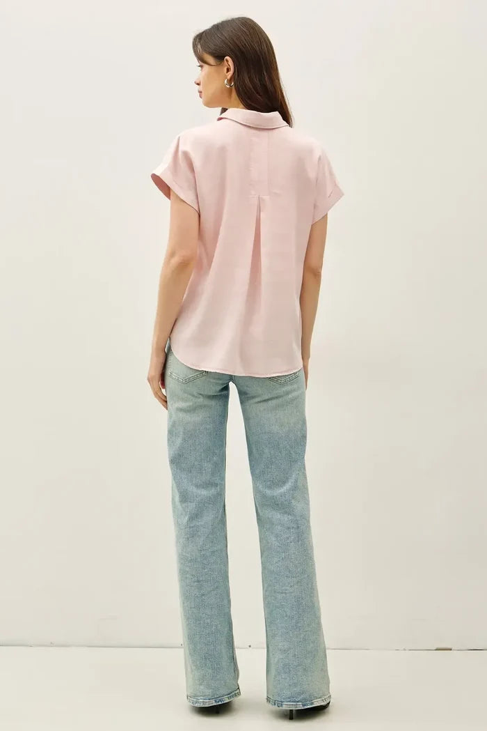 A soft pink short dolman sleeve button down shirt with classic collar and subtle pleats at the back