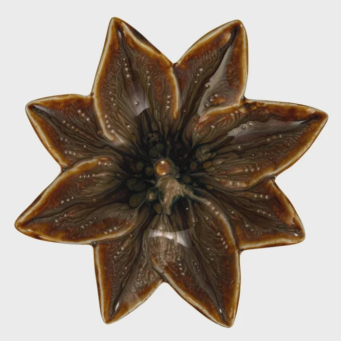 Brown glossy stoneware flower shaped dish with eight-pointed star design for decorative use