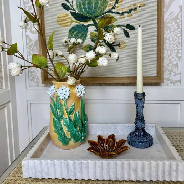 Yellow ceramic stoneware flower shaped dish with white and green floral relief artwork