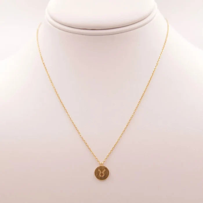 Gold coin Taurus Zodiac sign necklace elegantly displayed for stylish astrology enthusiasts